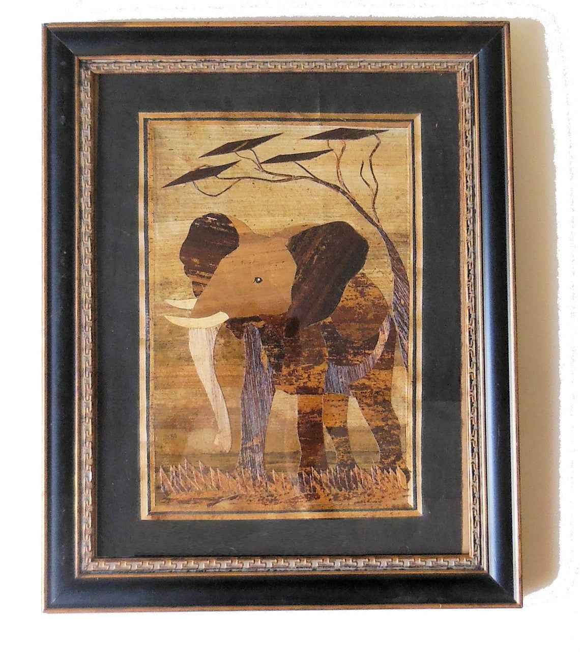 Tanzania- Intricately cut wood elephant on Fabric. Framed.